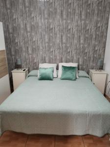 a bedroom with a large bed with two night stands at Casa rural con piscina privada Manitaga. in Tuineje