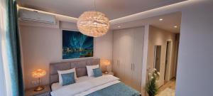 a bedroom with a bed and a chandelier at Beograd na vodi - BW AURORA LUXURY in Belgrade