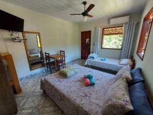 a living room with two beds and a couch at Pousada Flor da Manhã in Sana