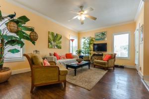 a living room with furniture and a ceiling fan at Five O'clock Somewhere 4Bd By Pkrm in Pensacola
