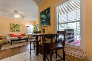 a living room with a table and a window at Five O'clock Somewhere 4Bd By Pkrm in Pensacola
