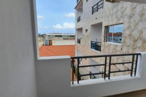 a balcony with a view of a building at 28A, Lumir Apartamento #8, Luanda in Luanda