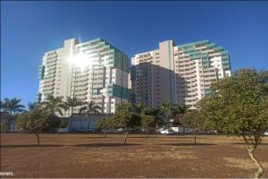 two tall buildings in a park with trees in front at Enjoy Olímpia Park Resort in Olímpia