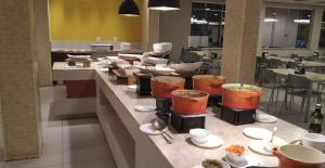 a kitchen with a counter with a bunch of food at Enjoy Olímpia Park Resort in Olímpia