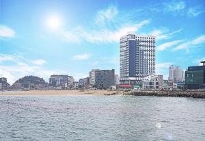 a view of a city with a beach and buildings at Heavenmark in Sokcho in Sokcho
