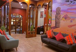 a lobby with two couches and a painting on the wall at Pukara Puka Kantuta in Puno