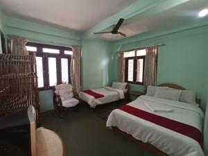 Una cama o camas en una habitación de Pushpa Guest House