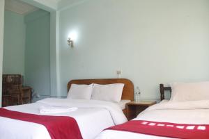 Una cama o camas en una habitación de Pushpa Guest House