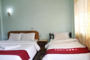 Una cama o camas en una habitación de Pushpa Guest House