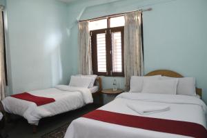 Una cama o camas en una habitación de Pushpa Guest House