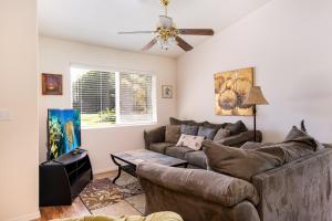 a living room with a couch and a ceiling fan at Pukeawe Hale in Volcano