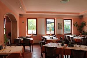 a dining room with tables and chairs and windows at Hotel Kunibert der Fiese - Superior in Cologne