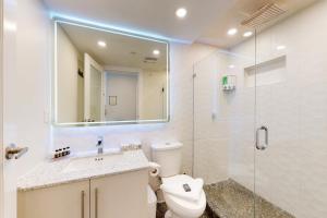 a bathroom with a toilet and a sink and a shower at Market Place Lodge 249 in Whistler