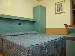 A bed or beds in a room at Atlantide Hotel