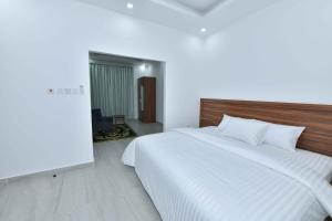 Ένα ή περισσότερα κρεβάτια σε δωμάτιο στο Summit Hotel Suites - القمة للأجنحة الفندقيه