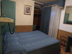 A bed or beds in a room at Atlantide Hotel