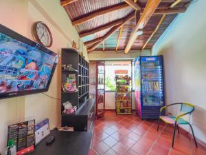 a room with two refrigerators and a tv in a room at Hotel Campestre La Trinidad in San Gil