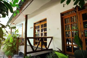 a room with a wooden door and some plants at La Fontana Zanzibar in Kendwa