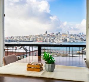 a balcony with a table and a view of the city at Sayeban Gold Hotel in Istanbul