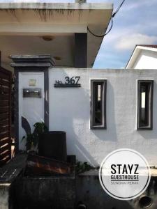 a house with a sign that says stay guest house at Stayz Guesthouse in Sungkai
