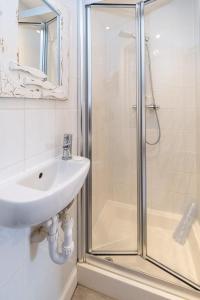 a bathroom with a sink and a shower at East Green Farm Cottage - Studio Barn - Aldeburgh Coastal Cottages in Kelsale