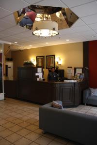 a waiting room with a man at a counter at SF Plaza Hotel in San Francisco