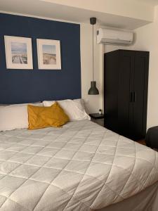 a bedroom with a large bed with a blue wall at Galè Apartment in Bologna