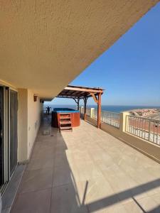 a balcony of a house with a view of the ocean at Amazing sea view Pentahouse Apartment in Pyramids Porto El-Sokhna in Ain Sokhna
