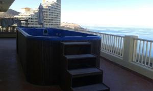 a blue tub on a balcony with the ocean at Amazing sea view Pentahouse Apartment in Pyramids Porto El-Sokhna in Ain Sokhna