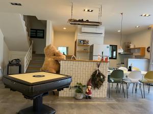 a kitchen with a teddy bear sitting on a counter at Less is more in Wujie