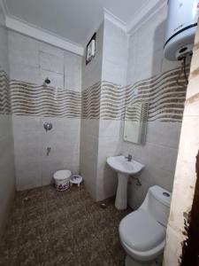 a bathroom with a toilet and a sink at Hotel Broadway Katra by Geetanjali Group of Hotels in Katra