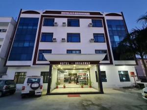 a large white building with a front entrance at Hotel Broadway Katra by Geetanjali Group of Hotels in Katra