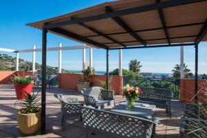 a patio with chairs and a table with flowers on it at ibis budget Cannes Mougins in Mougins