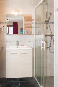 a bathroom with a sink and a shower at Gîte Châtel in Châtel