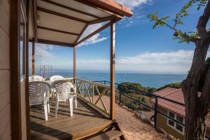 a deck with two chairs and a table on a balcony at Camping Roca Grossa in Calella