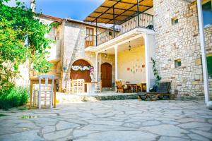a house with a patio with chairs and a table at annemin harabesi otel in Çeşme