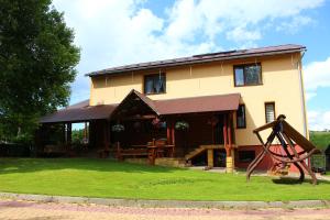 a house with a playground in front of it at Knieja u Andrzeja in Lutowiska
