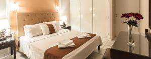 a hotel room with a bed with two towels on it at Lida Apartments in Kalamata