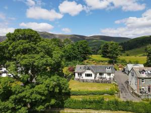 an aerial view of a house with mountains in the background at Borrowdale View in Keswick