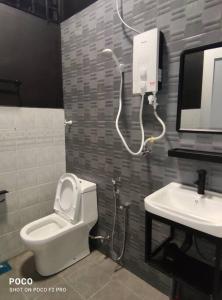 a bathroom with a toilet and a sink at 55 homestay 4-bedrooms guesthouse in Bukit Bakri Muar Johor in Bakri