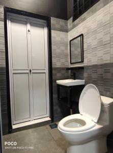 a bathroom with a toilet and a sink at 55 homestay 4-bedrooms guesthouse in Bukit Bakri Muar Johor in Bakri