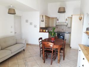 a kitchen with a table and chairs and a couch at Casa Afrodite in Praiano