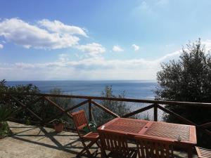a table and chairs on a balcony with the ocean at Casa Afrodite in Praiano