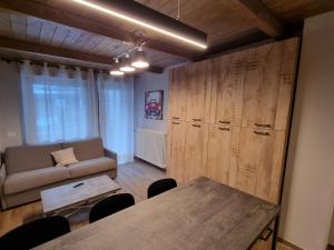 a living room with a table and a couch at Moda Apartments 38 in Sestriere