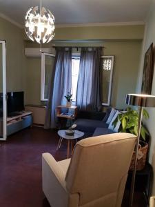 a living room with a couch and a table at Santi Padri Apartment in Corfu