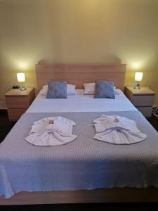 a bedroom with a bed with towels on it at Santi Padri Apartment in Corfu