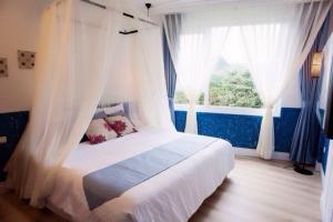 Postel nebo postele na pokoji v ubytování 墾丁合歡8宿-Ho Huan B & B