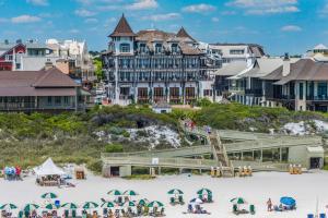 a group of people on the beach in front of a hotel at The Blue Lagoon in Rosemary Beach