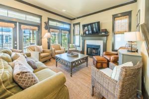a living room with a couch and a fireplace at Comfort and Joy in Seacrest