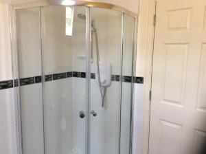 a shower with a glass door in a bathroom at Kilronan 4 Bed House on castle grounds in Ballyfarnon